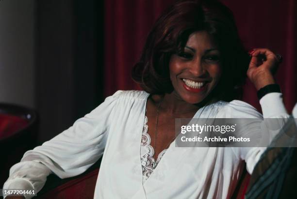 Tina Turner smiling while seated at a press conference for Ken Russell's film 'Tommy', 18th March 1975.