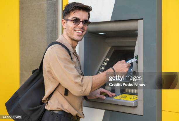 using atm - man atm smile stock pictures, royalty-free photos & images