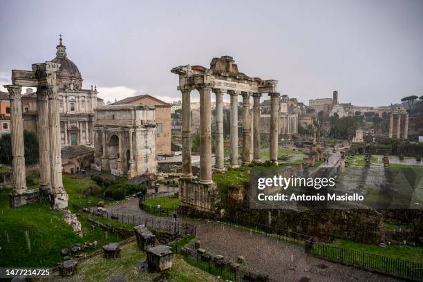 General view of the ancient Roman Forum ruins and the Colosseum during a hailstorm, on March 27, 2023 in Rome, Italy.