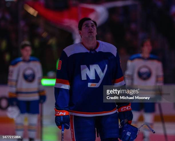 Alexander Romanov of the New York Islanders stands for the national anthem prior to the game against the Buffalo Sabres at UBS Arena on March 25,...
