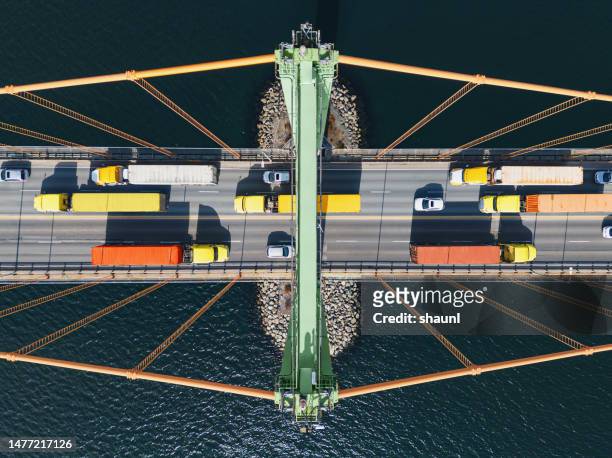 semi trucks crossing bridge - supply chain stock pictures, royalty-free photos & images