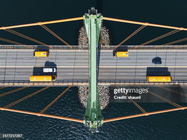 school buses cross bridge - transportation stock pictures, royalty-free photos & images