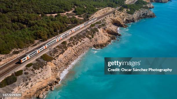 train tracks passing near the coastline along the mediterranean sea - vacation train stock pictures, royalty-free photos & images