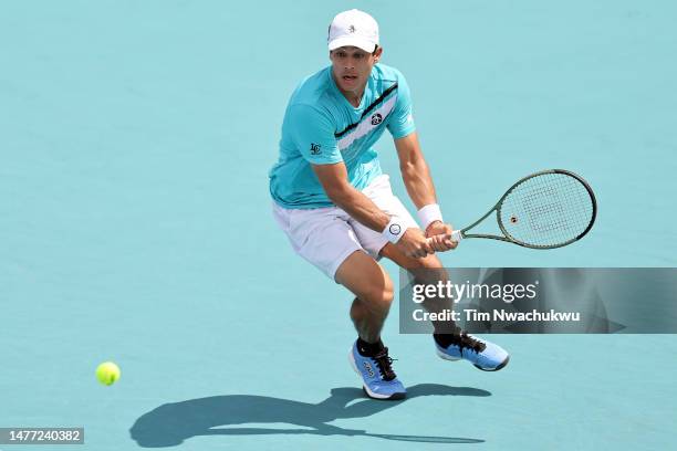 Mackenzie McDonald of the United States returns a serve to Quentin Halys of France during the Miami Open at Hard Rock Stadium on March 27, 2023 in...