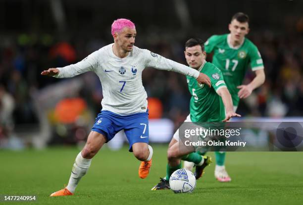 Antoine Griezmann of France controls the ball while under pressure from Josh Cullen of Republic of Ireland during the UEFA EURO 2024 qualifying round...