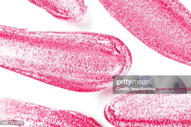 pink lipstick smears on white background, isolated. lip gloss samples are smudged. beauty cosmetic pattern. makeup and skin care products. - pink lipstick smear stock pictures, royalty-free photos & images