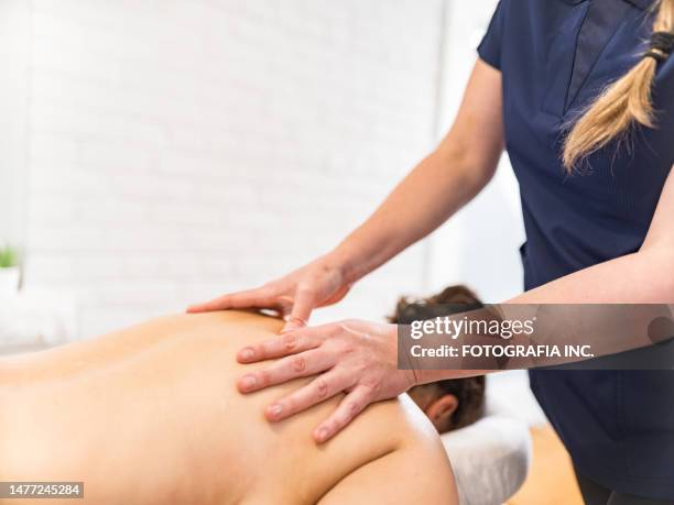 hands of female massage therapist treating female patient - pressure point bildbanksfoton och bilder