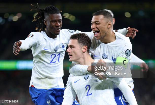 Benjamin Pavard of France celebrates with teammates Kylian Mbappe and Eduardo Camavinga after scoring the team's first goal during the UEFA EURO 2024...