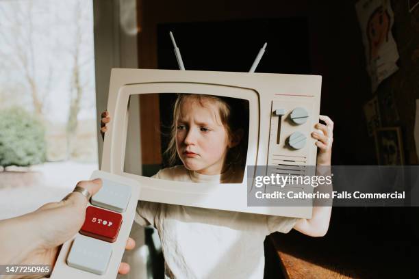 a little girl is dramatic as she pretends to be an actress on a toy television - cross channel stock pictures, royalty-free photos & images