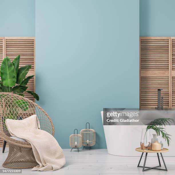 cozy retro-chic interior with an art deco rattan rounded wicker armchair, bathtub and potted plants, 50s- 60s decoration - bird cage stock pictures, royalty-free photos & images