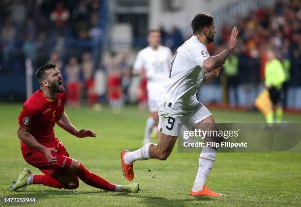 Igor Vujacic of Montenegro reacts after being challenged by Aleksandar Mitrovic of Serbia during the UEFA EURO 2024 qualifying round group B match...