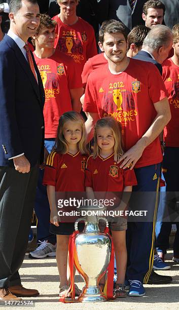 Spain' s Prince Felipe , Spain's goalkeeper and captain Iker Casillas , and Princesses Leonor and Sofia pose with the EURO 2012 trophy at the...