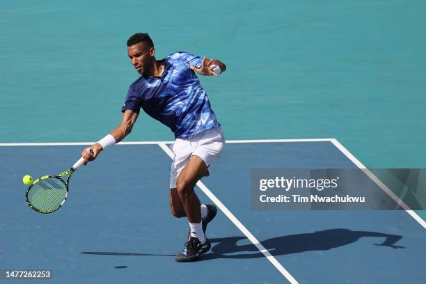 Felix Auger Aliassime of Canada returns a serve to Francisco Cerundolo of Argentina during the Miami Open at Hard Rock Stadium on March 27, 2023 in...