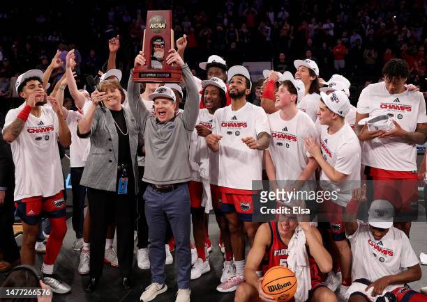 The Florida Atlantic Owls celebrate with the East Regional trophy after defeating the Kansas State Wildcats 79-76 in the Elite Eight round game of...