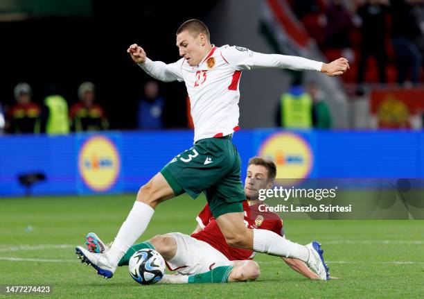 Barnabas Varga of Hungary slide tackles Valentin Antov of Bulgaria during the UEFA EURO 2024 qualifying round group B match between Hungary and...