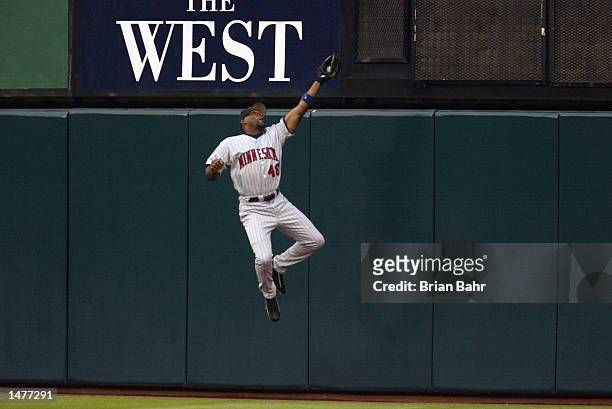 Center fielder Torii Hunter of the Minnesota Twins makes a catch at the wall to end the first inning against the Anaheim Angels in game three of the...