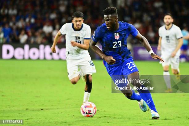 Daryl Dike of the United States dribbles the ball up field against Tomas Romero of El Salvador in the first half of a game at Exploria Stadium on...