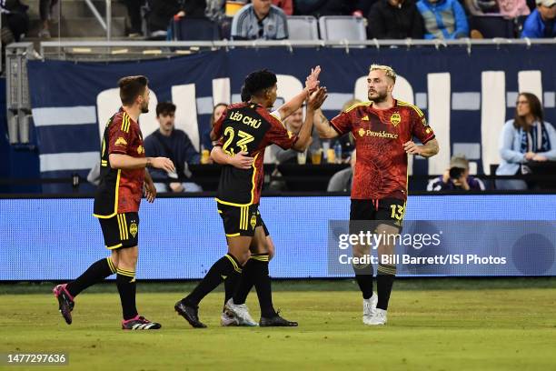 Seattle Sounders celebrate a goal during a game between Seattle Sounders FC and Sporting Kansas City at Children's Mercy Park on March 25, 2023 in...