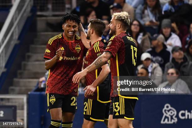 Leo Chu , Kelyn Rowe and Jordan Morris of Seattle Sounders FC celebrate a goal during a game between Seattle Sounders FC and Sporting Kansas City at...
