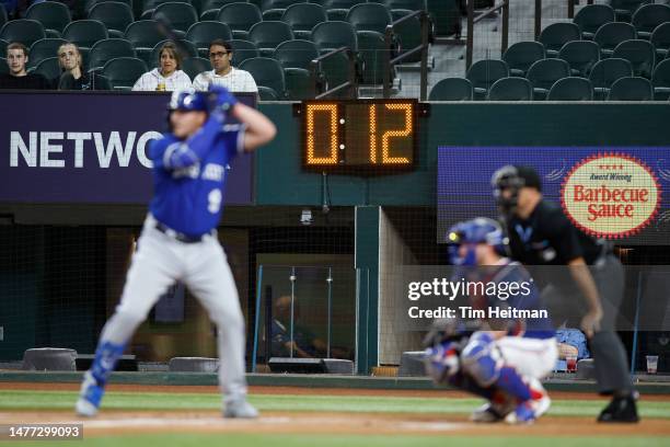 Vinnie Pasquantino of the Kansas City Royals bats with a pitch clock in the background in the first inning against the Texas Rangers at Globe Life...