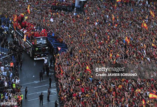 The Spanish national football team arrives on Cibeles Square on July 2, 2012 after parading through Madrid, a day after it won the final match of the...