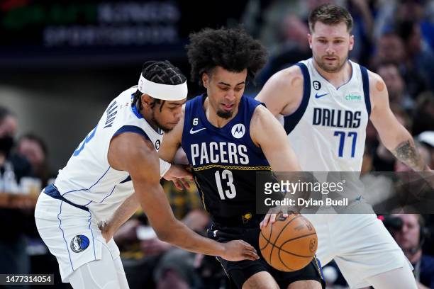 Jordan Nwora of the Indiana Pacers dribbles the ball while being guarded by Jaden Hardy of the Dallas Mavericks in the third quarter at Gainbridge...