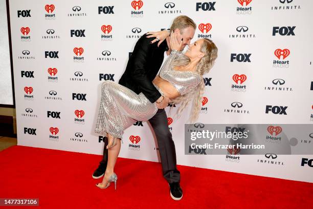 Brian Austin Green and Sharna Burgess pose in the press room during the 2023 iHeartRadio Music Awards at Dolby Theatre on March 27, 2023 in...