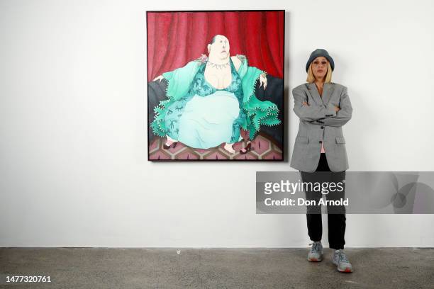Artist Caroline Zilinsky poses beside her 2023 Archibald entry , a portrait of Drag Queen Maxi Shield titled 'Drama Queen', at Nanda/Hobbs Gallery in...