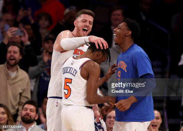 Immanuel Quickley of the New York Knicks is congratulated by teammates Isaiah Hartenstein and RJ Barrett as Quickley is taken out of the game in the...