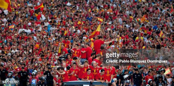 Spain players celebrate with their fans and the UEFA EURO 2012 trophy on a double-decker bus during the Spanish team's victory parade on July 2, 2012...