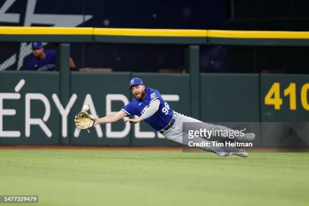 John Rave of the Kansas City Royals cannot catch a ball hit by Josh Smith of the Texas Rangers in the seventh inning at Globe Life Field on March 27,...