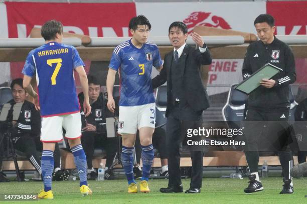 Japan head coach Hajime Moriyasu gives instruction to his players during the international friendly match between Japan and Uruguay at the National...