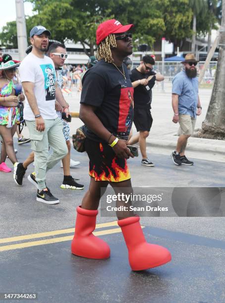 An electronic dance music fan wears anime-inspired Astro Boy Big Red Boots with beach board shorts with a flame motif, during Miami Music Week at the...