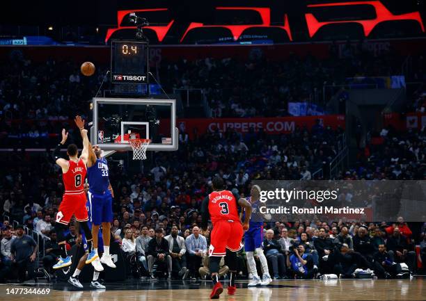 Zach LaVine of the Chicago Bulls makes a shot against Nicolas Batum of the LA Clippers at the end of the first quarter at Crypto.com Arena on March...