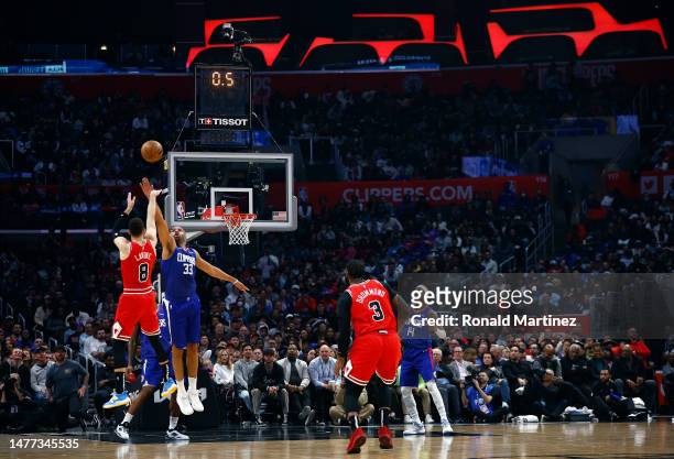 Zach LaVine of the Chicago Bulls makes a shot against Nicolas Batum of the LA Clippers at the end of the first quarter at Crypto.com Arena on March...