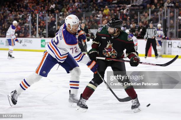 Nick Bjugstad of the Edmonton Oilers shoots the puck against Connor Mackey of the Arizona Coyotes during the second period of the NHL game at Mullett...
