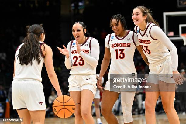 Georgia Amoore, Kayana Traylor, Taylor Soule and Elizabeth Kitley of the Virginia Tech Hokies celebrate after defeating the Ohio State Buckeyes 84-74...