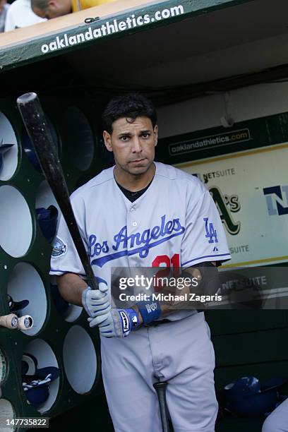 Juan Rivera of the Los Angeles Dodgersstands in the dugout prior to the game against the Oakland Athletics at the Oakland-Alameda County Coliseum on...