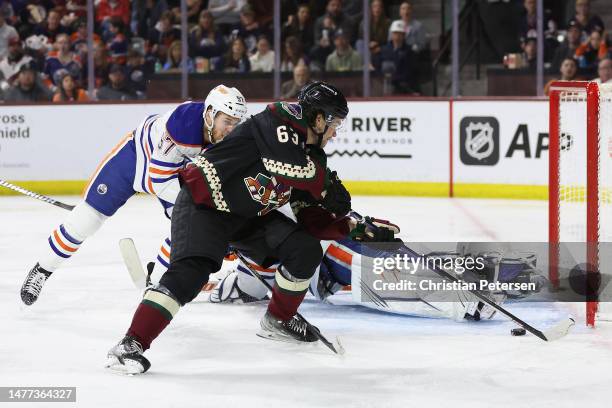 Matias Maccelli of the Arizona Coyotes shoots to score a goal past goaltender Jack Campbell of the Edmonton Oilers during the third period of the NHL...