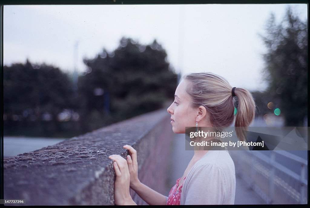 Woman looking over wall
