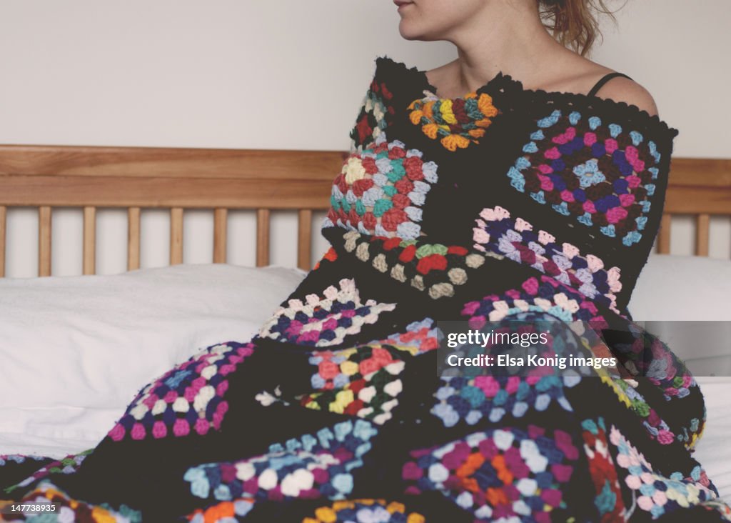 Woman wrapped in handmade blanket