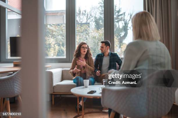 fresh heterosexual couple explaining the situation to therapist - conflict resolution stock pictures, royalty-free photos & images