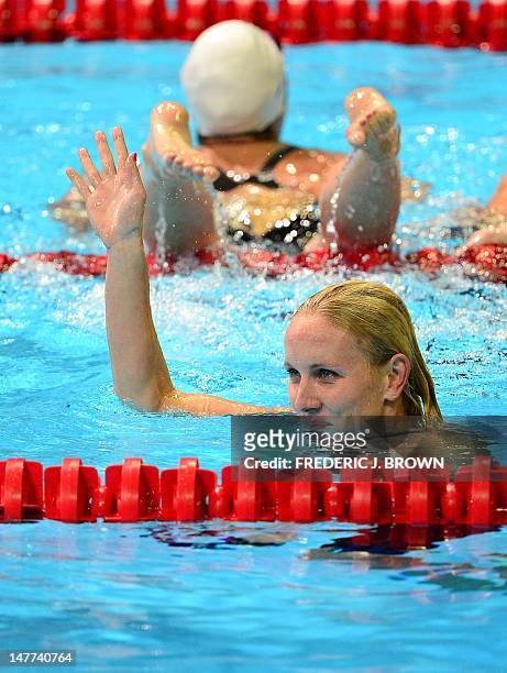Jessica Hardy waves to the crowd following her first place finish in the women's 50M Freestyle final on the last day of the 2012 US Olympic Team...