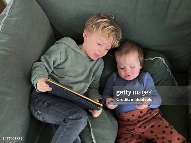 toddler and baby going digital - family time stock pictures, royalty-free photos & images