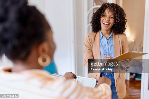 female nutritionist weighing patient on biometric scale during medical consultation - nutritionist stock pictures, royalty-free photos & images