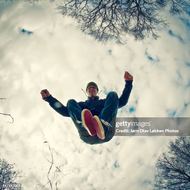 man jumping - view from below fotografías e imágenes de stock