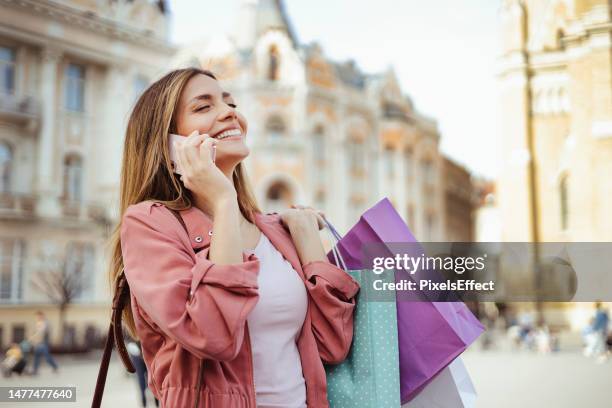 city shopping and phone call - shopping bag stock pictures, royalty-free photos & images