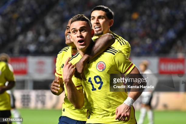 Rafael Santos Borre of Colombia celebrates after scoring the team's second goal with teammates Jhon Arias and Daniel Munoz during the international...