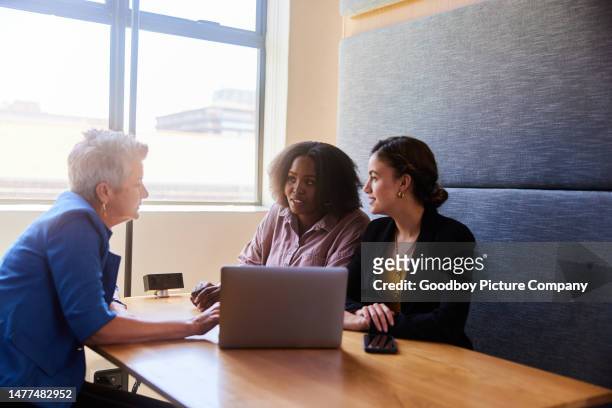 diverse businesswomen smiling during a meeting in an office cubicle - corporate modern office bright diverse imagens e fotografias de stock