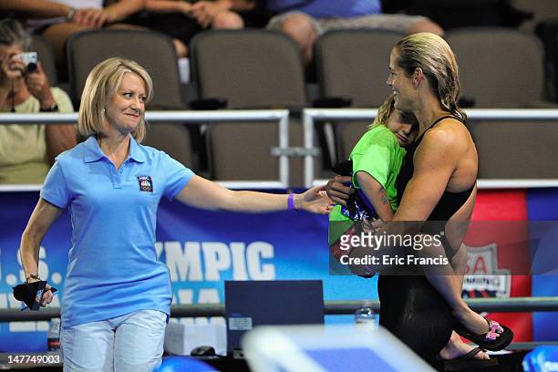 Dara Torres holds her daughter Tessa and prepares to be interviewed after failing to qualify in the 50m Freestyle during day eight of the 2012 U.S....